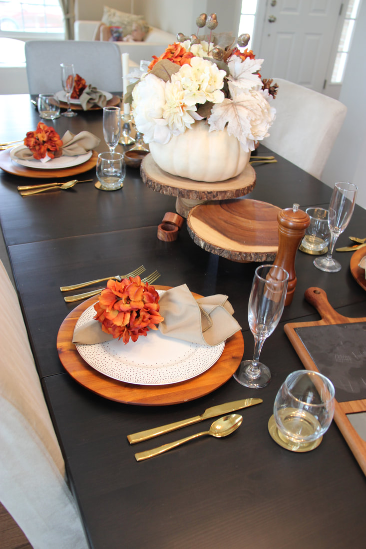 Fall tablescape with acacia wood and pumpkin decor.